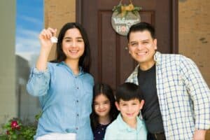 a family standing infront of their new home