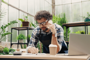 small business owner sitting at his desk talking on the phone